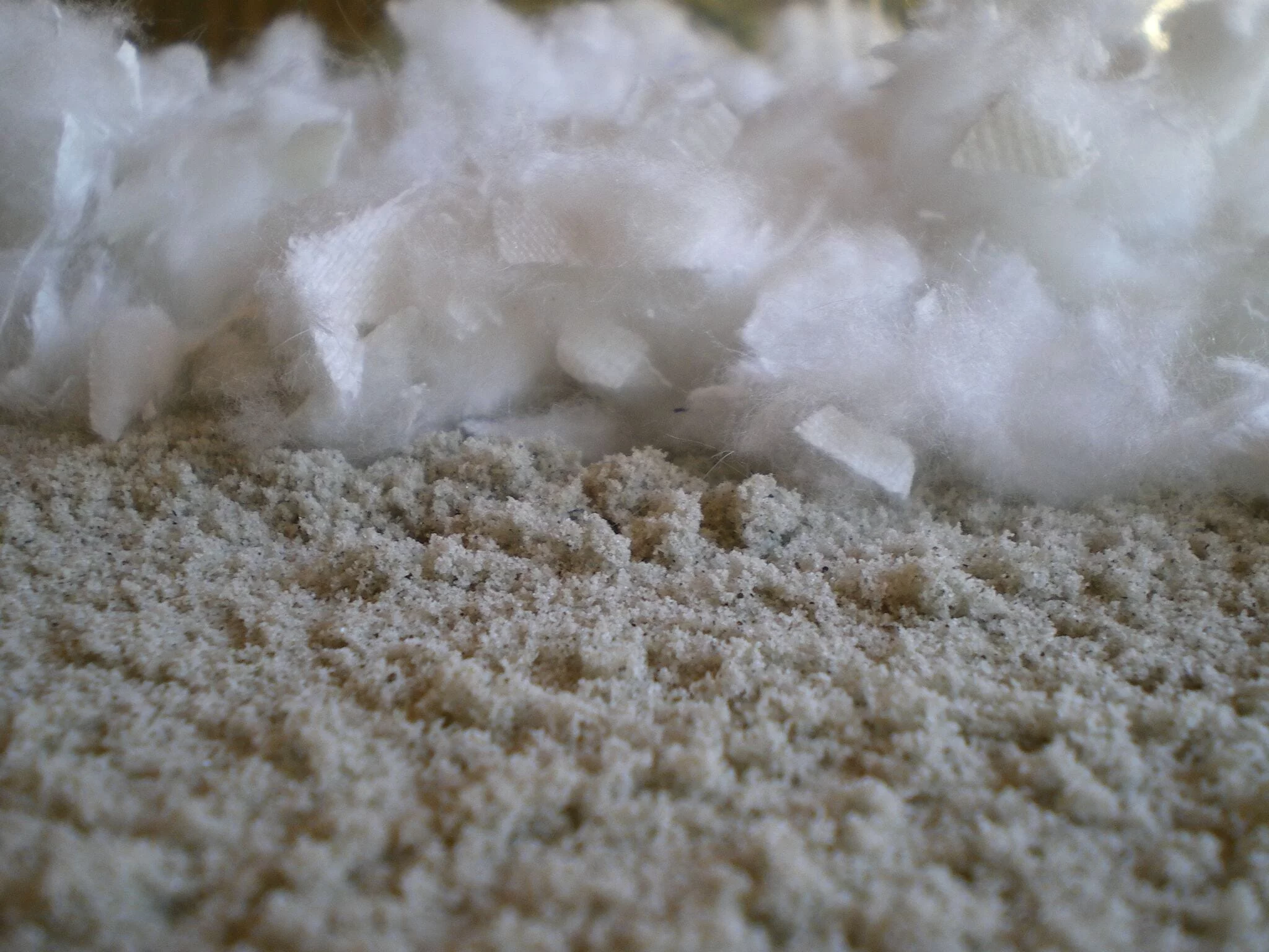 Synthetic arena fiber blended evenly through equestrian sand matrix