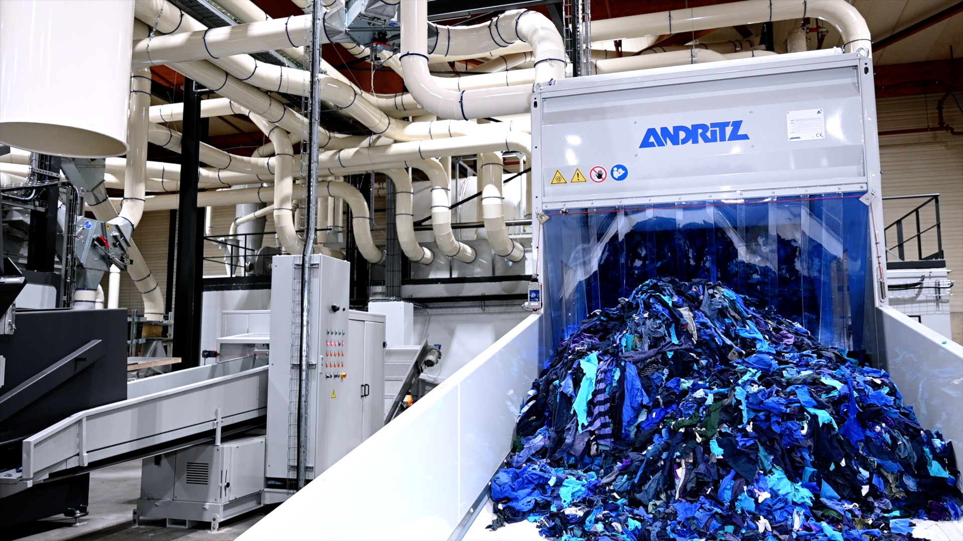 Industrial textile cutting and shredding facility for arena flakes